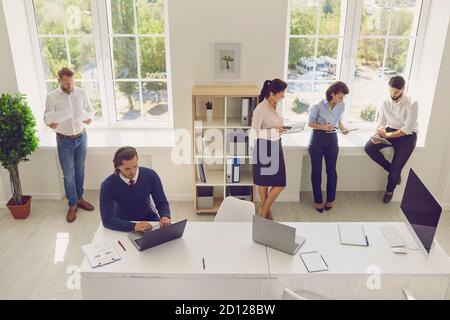 Young concentrated creative coworkers working with new startup project in modern office. Stock Photo