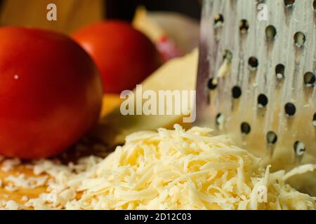 Grated cheese and tomatoes in close-up. Stock Photo