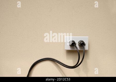 Electric wire plug Receptacle on the concrete wall background Stock Photo