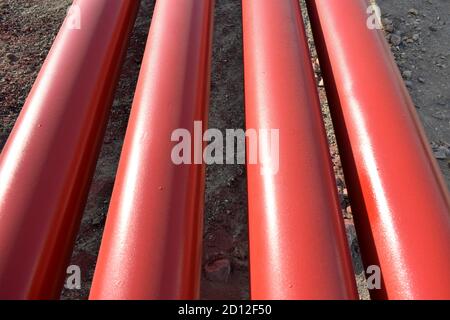 Red steel pipes for fire fighting system and extinguishing water lines in industrial building. Paint shop. Steel pipe painted red color. Stock Photo