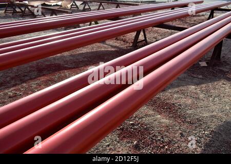 Red steel pipes for fire fighting system and extinguishing water lines in industrial building. Paint shop. Steel pipe painted red color. Stock Photo