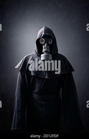 Man in a gas mask and hooded cloak. Environment pollution. Stock Photo