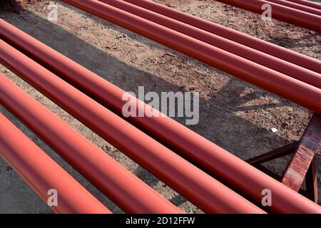 Red steel pipes for fire fighting system and extinguishing water lines in industrial building. Paint shop. Steel pipe painted red color. Stock Photo