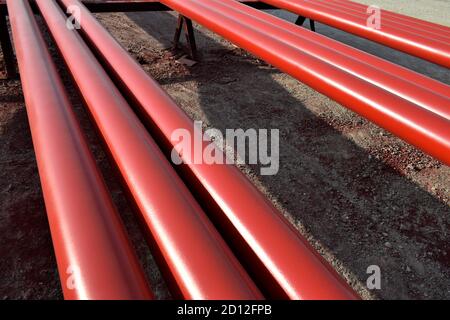 Red steel pipes for fire fighting system and extinguishing water lines in industrial building. Paint shop. Steel pipe painted red color. Stock Photo