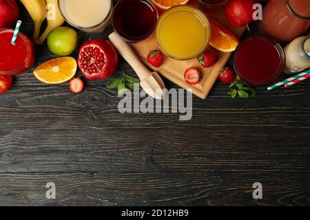 Glasses and jars with different juices on wooden background Stock Photo