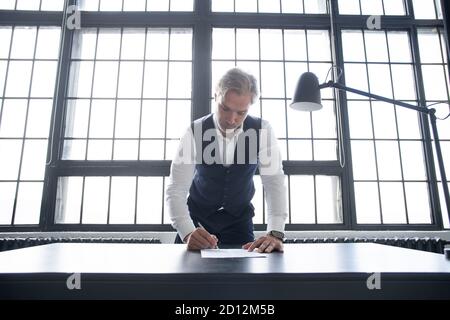 Business man signing contract making a deal, classic business. Stock Photo