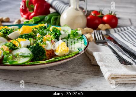 a plate of indonesian gado gado salad with rice, eggs and green vegetables Stock Photo