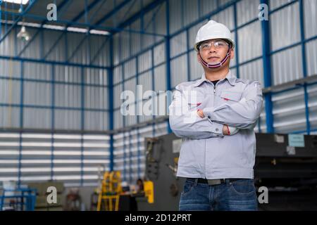 Portrait of manual asian man worker is standing confident with confident with working suite dress and safety helmet of high technology clean industry Stock Photo