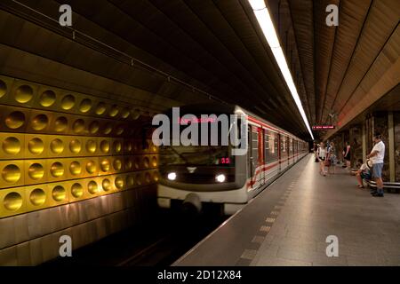 Underground station with people on platform waiting for subway train in Prague, Czech Republic, Europe. Commuters traveling on public metro transport Stock Photo