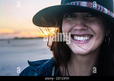 Young woman portrait on beach sunset. Close-up. Stock Photo