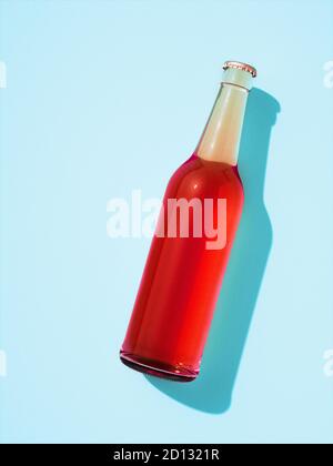 One transparent glass bottle with metal cap laying on light blue surface. Beer bottle full of red drink without label. Retro drink bottle concept. Stock Photo