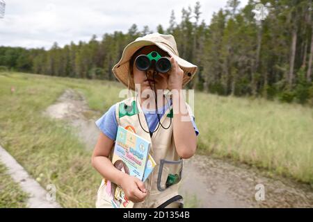 Girl learning about nature in an outdoor class. Stock Photo