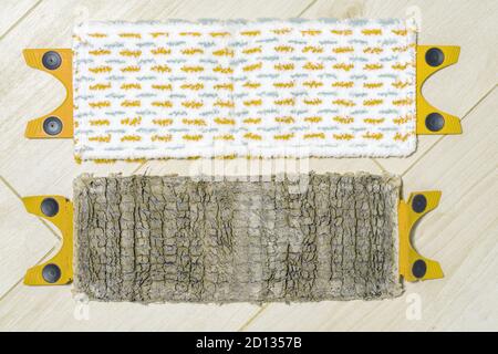 old and new mop cloths lie side by side on the floor Stock Photo