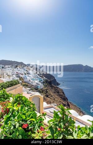 Beautiful view of Oia, the famous town with its typical white houses on a sunny day. Santorini island, Cyclades, Greece, Europe. Portrait format Stock Photo