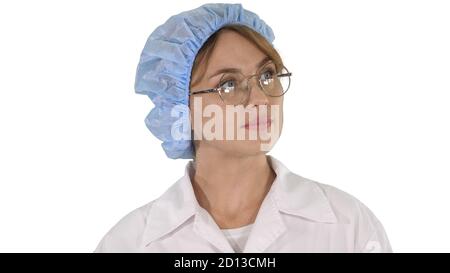 Woman doctor in glasses and hat walking and looking around on wh Stock Photo