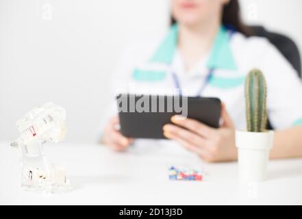 The doctor recreates the stencil based on the patient s computer data using a computer tablet. Concept of modern technology in medicine 3D dental impl Stock Photo