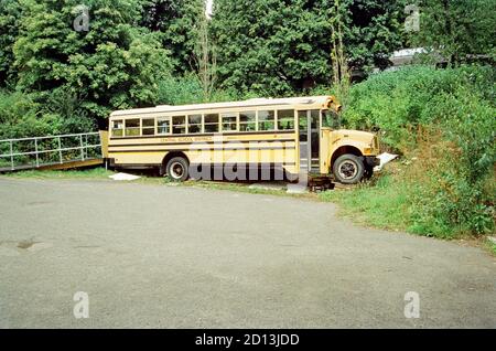 Yellow American school bus converted into a rum distillery, Dartington Cider Press, Devon, England, United Kingdom. Stock Photo