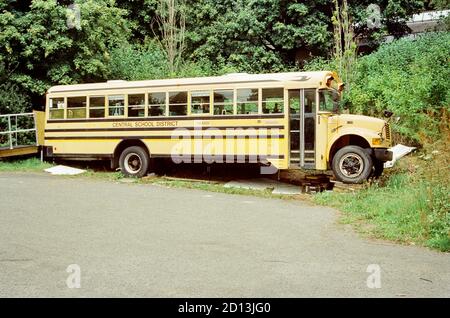 Yellow American school bus converted into a rum distillery, Dartington Cider Press, Devon, England, United Kingdom. Stock Photo