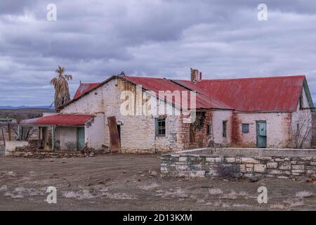 Abandoned, derelict old farmhouse in the Leeu Gamka district in the central Karoo in South Africa on an overcast day Stock Photo