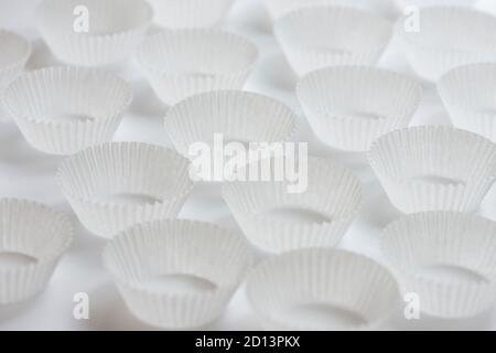 Empty paper cupcakes molds on white background Stock Photo