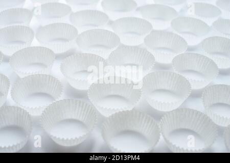 Empty paper cupcakes molds on white background Stock Photo
