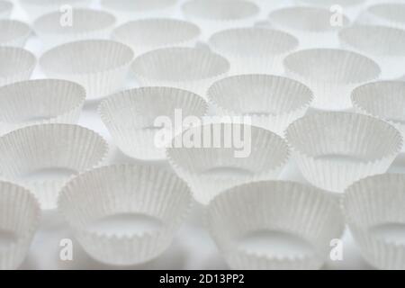 Empty paper cupcakes molds on white background Stock Photo