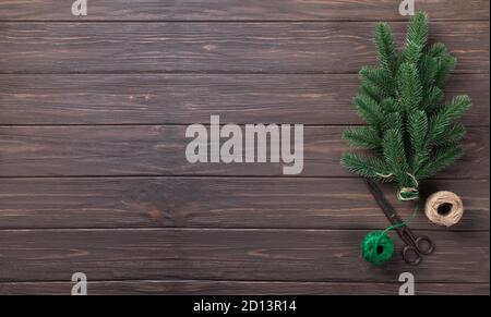 Bouquet of fir branches tied with twine on a wooden table. Stock Photo