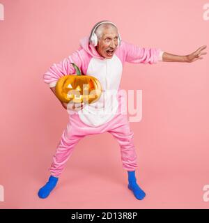 Basketball man holding pumpkin with bright emotion on pink. Copyspace for your ad. Modern design. Contemporary artwork, collage. Concept of Halloween, Night of fear, trick or treat, jack-o-lanterns Stock Photo