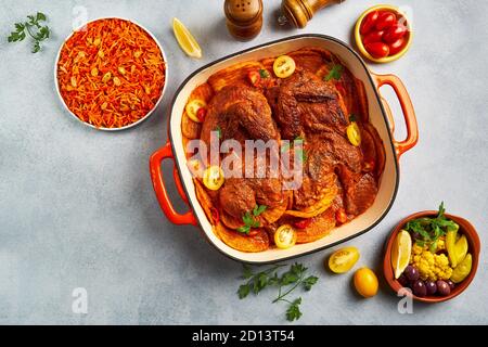 Roasted chicken with potatoes in red sauce. Top view Stock Photo