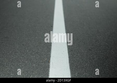 White lane markings on paved roads Stock Photo