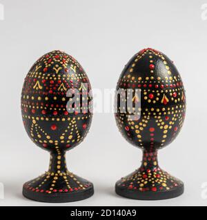Colorful handmade wooden easter egg on a white background. Hand painted easter two eggs with acrylic paints, handwork, dot painting, close up, Ukraine Stock Photo