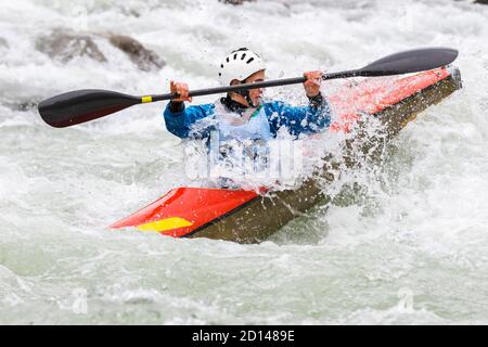 engaged athlete downhill with canoe Stock Photo