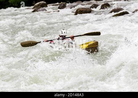 engaged athlete downhill with canoe Stock Photo