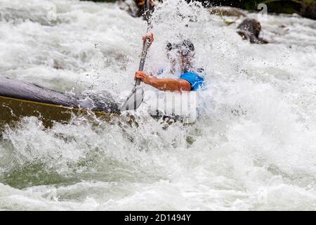 engaged athlete downhill with canoe Stock Photo