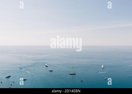 View of the Mediterranean sea from the city of Taormina, Italy with sailboats and motorboats on a sunny summer day Stock Photo