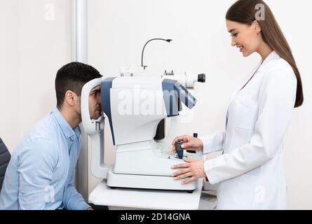 Optometrist checking patients vision at modern clinic Stock Photo