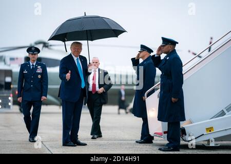 President Donald Trump gestures as he boards Air Force One, Saturday ...
