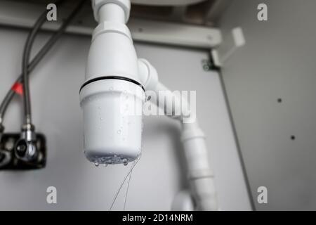 leaking sink trap. broken siphon. sewage water leakage Stock Photo