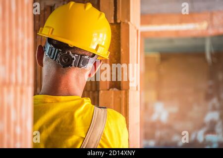 Construction Worker in His 40s Wearing Yellow Hard Hat Close Up. Construction Industry Job Theme. Stock Photo