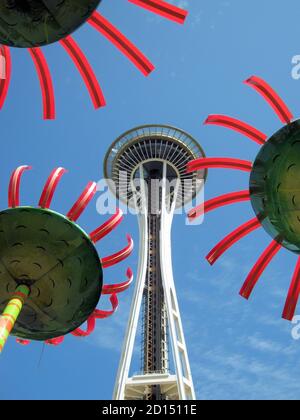 Seattle’s iconic spire framed by whimsical flower sculptures at Seattle Center.