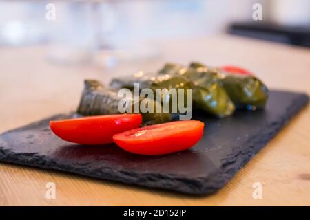 Dolma, delicious Casucasian and Turkish cuisine, vine leaves stuffed with minced meat and rice. Stock Photo