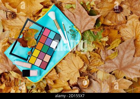 Hello november. autumn flat lay with leaves and makeup. Stock Photo