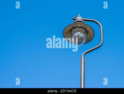 Old style street lamp with meral shade on metal post. Stock Photo