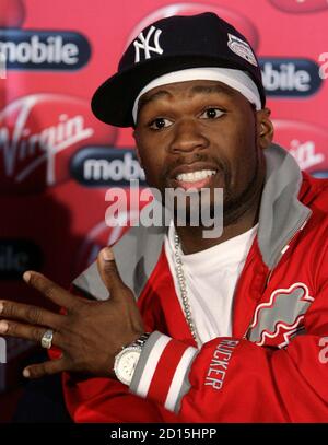 Rapper 50 Cent From The U S Holds Up A Condom During A Media Briefing At Lanseria Airport Outside Johannesburg April 30 08 50 Cent Together With His G Unit Crew Will Perform Twice