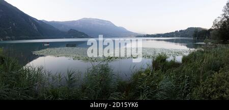 France, Savoie, Savoyard country, the lake of Aiguebelette, a little red riding hood on a boat in the early morning Stock Photo