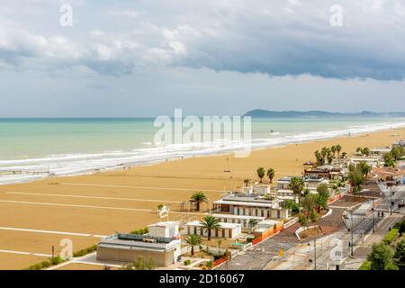 Aerial view of the beach of Rimini, Italy, in winter time, with the almost deserted beach and clouds in the sky Stock Photo
