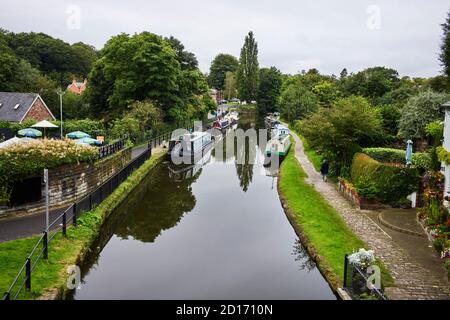 Looking down on the Bridgewater canal at Lymm village with moorings on both sides of the canal