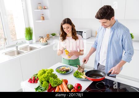 Portrait of two people prepare tasty delicious yummy steak roast frying lunch man serve plate girl season spicy hold mustard enjoy cooking weekend in Stock Photo