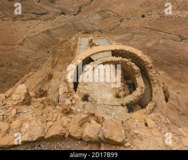 the middle terrace of the northern palace on a cloudy day at masada in israel from above with part of the lower terrace visible and a roman camp in th Stock Photo