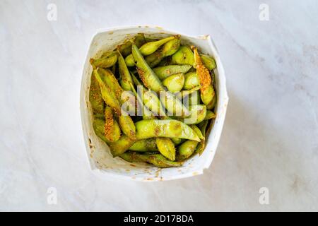 Take Away Steamed Edamame Bean, Green Soybean in a pan, East Asian Cuisine. Traditional Healthy Organic Food. Stock Photo